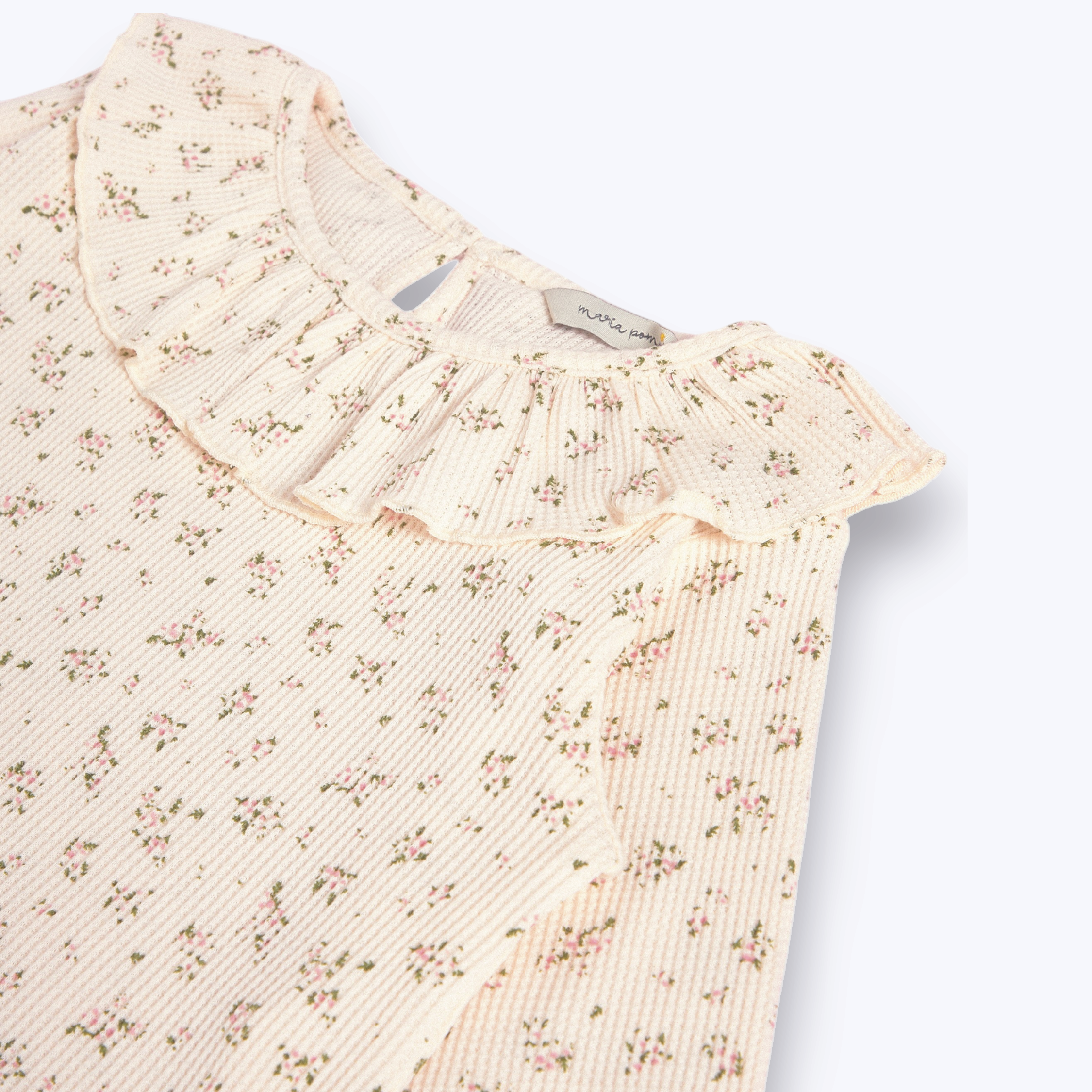 Polera cuello vuelo flor